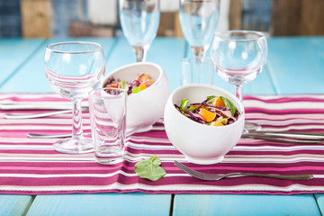 Red cabbage tangerines and pine nuts salad. Selective focus. Copy space.