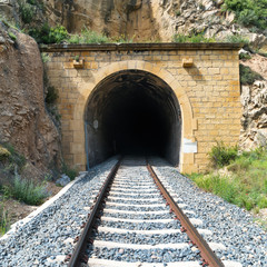 Fototapeta na wymiar Old train tunnel with railway in a mountain