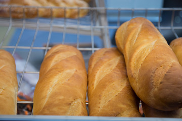 freshly baked bread and baked goods on the shelves on the counter of the bakery