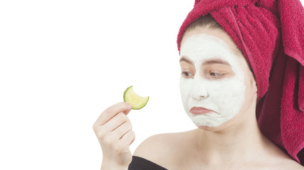 sad woman loonikg at cucumber for beauty mask