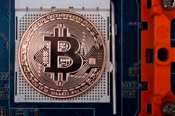 Bitcoin digital currency,  bit-coin on motherboard or electronic board with chips, Cryptocurrency money concept