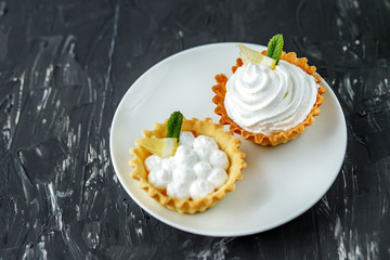 Sweet cake with cream, mint and lemon. The concept of food, desserts, restaurant.