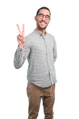 Naklejka premium Happy young man doing a gesture of victory