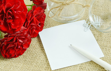 Paper with space for text and red roses