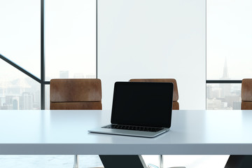 Blank laptop in meeting room