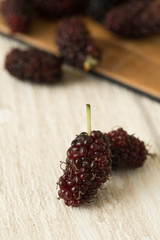 mulberry fruit fresh sour and sweet purple red on wood background