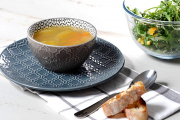 bowl of soup of vegetables on blue plate