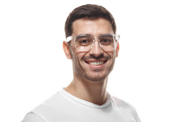 Joyful modern optimistic man smiles broadly, shows perfect teeth isolated on white background. Positive emotions, facial expressions and happiness concept.