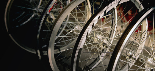 Bicycle wheels in a dark background.