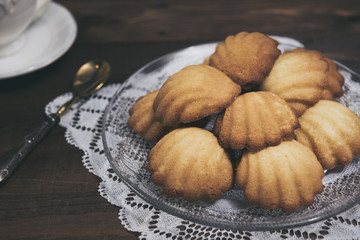 Homemade french madeleines with beurre noisette  on wooden table