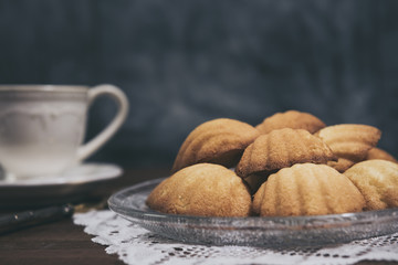 Homemade french madeleines with beurre noisette  on wooden table
