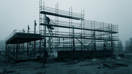 construction site building under construction: metallic structure and scaffolds