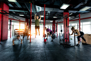 Fototapeta premium Athletes training in a cross-fit gym