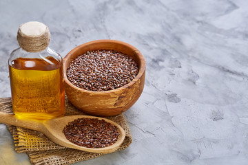 Close-up selective focus healthy flax seed on white textured background, macro, vertical.