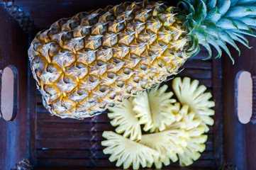 Pineapple in natural conditions on a beautiful tropical background. Exotic fruits