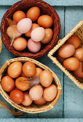 Beautiful raw eggs in baskets