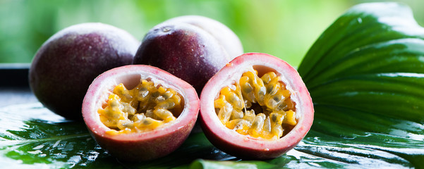 Passion fruit  in natural conditions on a beautiful tropical background. Exotic fruits