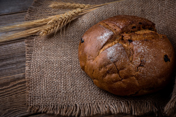  bread and wheat on an  rustic wood table