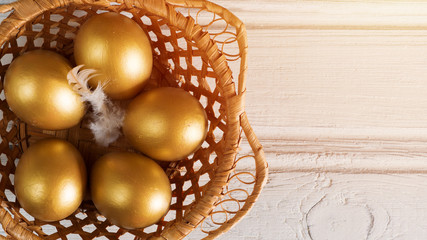 Fototapeta na wymiar Easter eggs gold in a basket