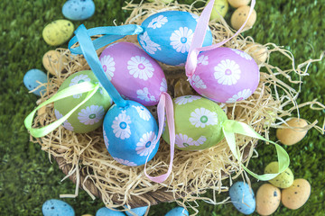 Fototapeta na wymiar Easter eggs in basket on grass