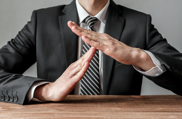 Businessman showing time-out gesture, body language
