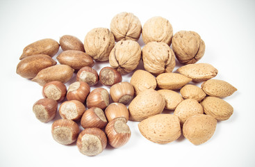Different types of nuts in a shell on a white background.
