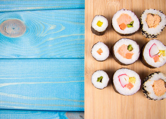 Various kinds of sushi on the blue background.