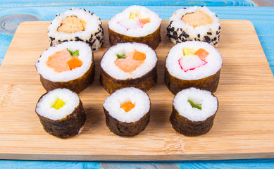 Various kinds of sushi on the blue background.