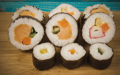 Various kinds of sushi on the blue background.