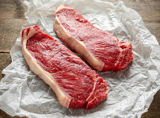 Raw premium beef sirloin steak on cooking paper