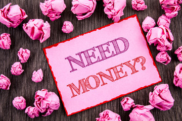 Handwriting text showing Need Money Question. Business photo showcasing Economic Finance Crisis, Cash Loan Needed written on Pink Sticky Note Paper Folded Paper on wooden background