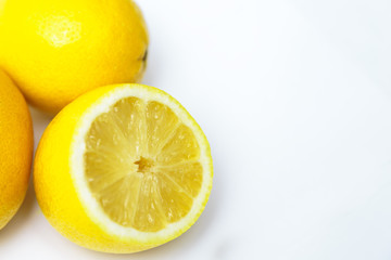 three yellow lemon one in a cut on a white background