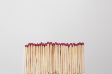 many matches with a red head on a white background