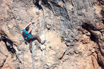 A man climbs the rock.