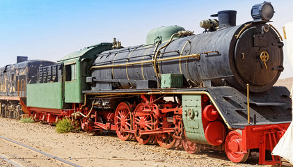 Fototapeta na wymiar Steam locomotive, still in use, in the desert of Wadi Rum, Jordan