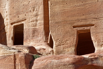 Close-up of two empty burial chambers and tombs in Petra, Jordan