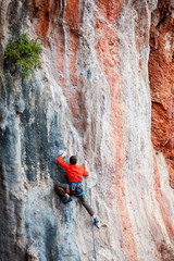 A man climbs the rock.