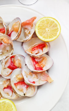fresh spanish conchas finas at plate with lemon