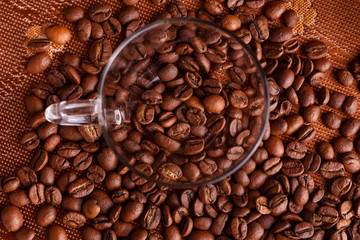 coffe beans in transparent mug on burlap background