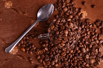 coffe beans in transparent mug on burlap background
