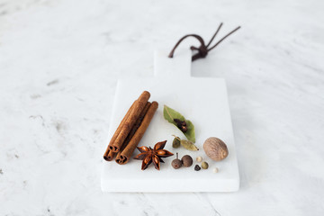 spices on a white marble background
