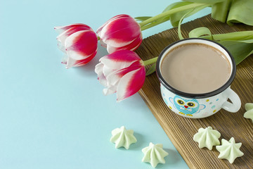 Red tulip white white border on blue background cacao cup marshmallow.