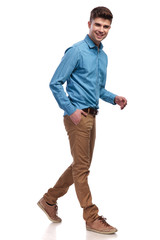 Naklejka premium side view of a laughing casual man walking