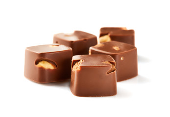 Assortment of chocolate candies sweets isolated on a white background. Chocolate candies collection. Milk chocolate with nuts.