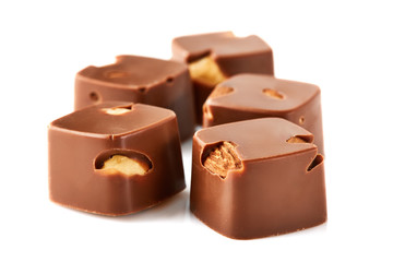 Assortment of chocolate candies sweets isolated on a white background. Chocolate candies collection. Milk chocolate with nuts.