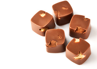 Assortment of chocolate candies sweets isolated on a white background. Chocolate candies collection. Milk chocolate with nuts.