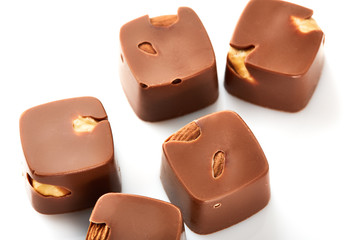 Assortment of chocolate candies sweets isolated on a white background. Chocolate candies collection. Milk chocolate with nuts.