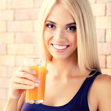 Beautiful blond woman drinking orange juice