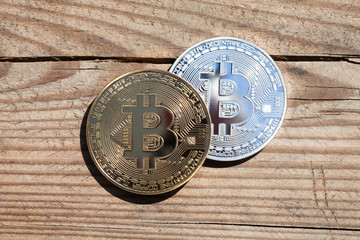 Bitcoin blockchain cryptocurrency golden, silver and bronze coins on a wooden