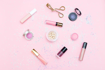 Obraz premium Cosmetics and accessories on a background of pink color. Flat lay
